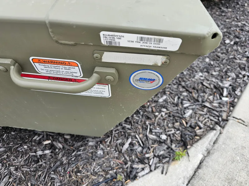 Slide: The Image of 2026 Tracker Grizzly 1236 Jon boat with warning labels and certification sticker. - 6