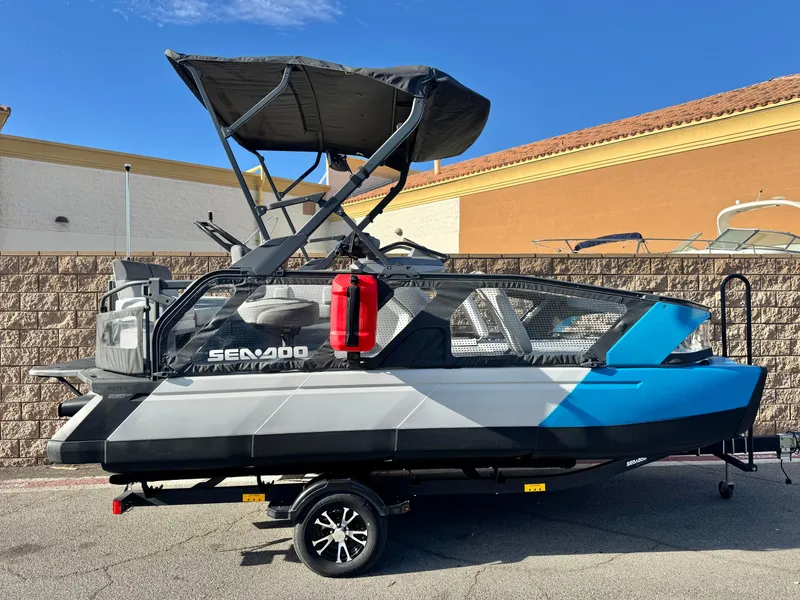 The Image of 2023 Sea-Doo Switch Sport 18 boat on trailer, featuring sleek design and vibrant blue accents. - 0