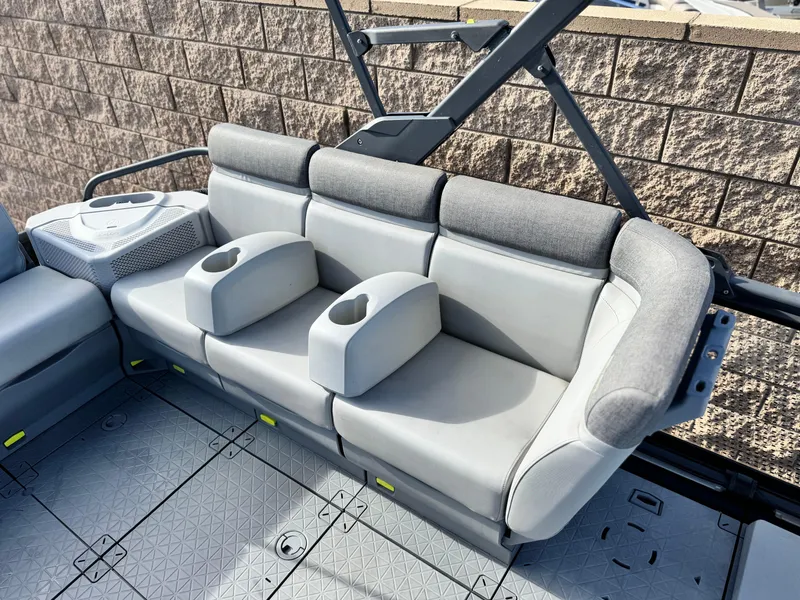Slide: The Image of 2023 Sea-Doo Switch Sport 18 interior seating with cup holders and gray upholstery. - 16