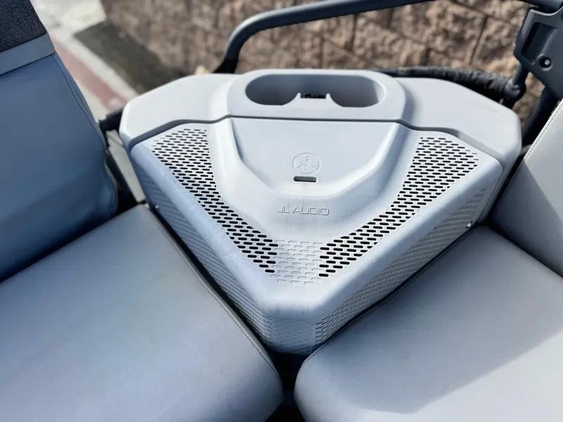 Slide: The Image of 2023 Sea-Doo Switch Sport 18 JL Audio speaker system on boat seating area. - 17