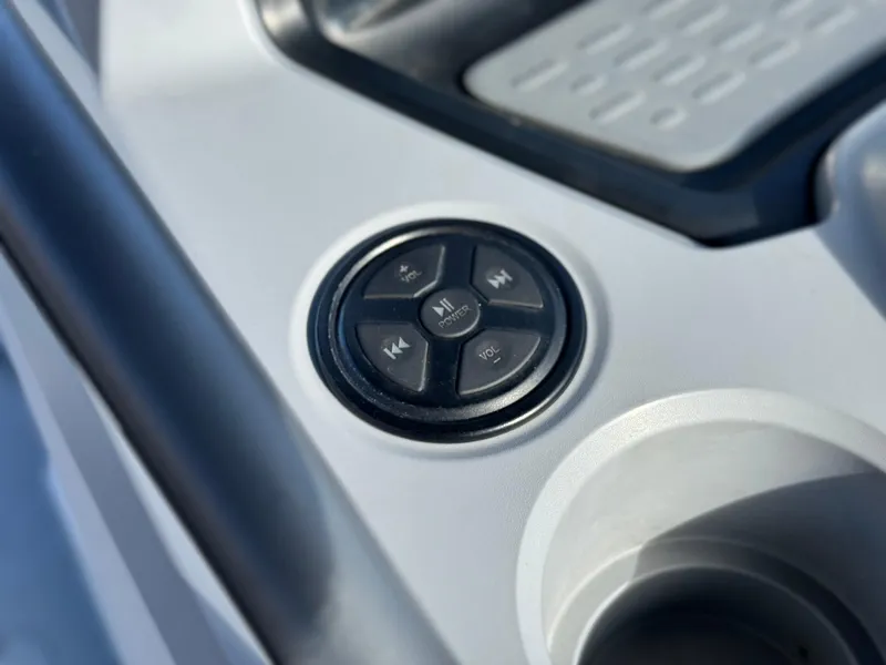 Slide: The Image of Close-up of 2023 Sea-Doo Switch Sport 18 audio control panel. - 25