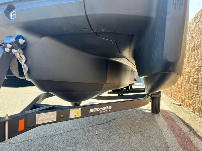 Slide: The Image of 2023 Sea-Doo Switch Sport 18 on trailer, close-up view of hull and trailer details. - 3