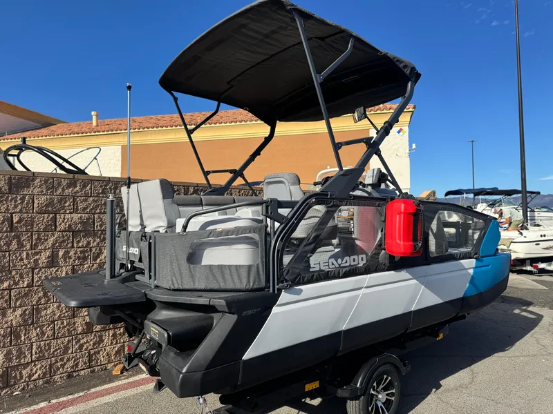 Slide: The Image of 2023 Sea-Doo Switch Sport 18 boat with canopy, parked outdoors. - 6