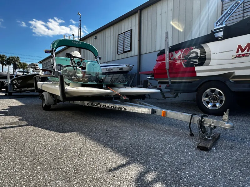 Slide: The Image of 2020 CraigCat CATCHIT boat on trailer, parked outside a building under a clear sky. - 10