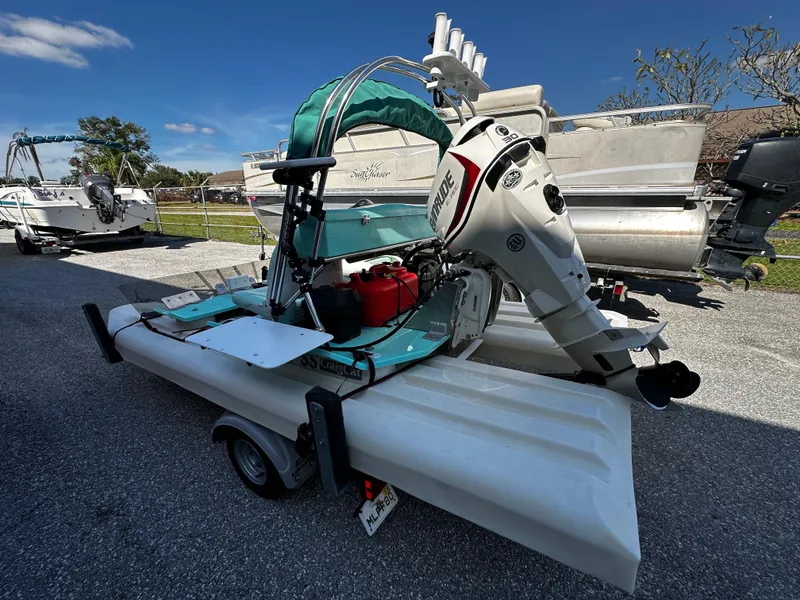 Slide: The Image of 2020 CraigCat CATCHIT boat on trailer, featuring outboard motor, parked outdoors under clear sky. - 3