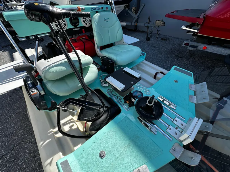 Slide: The Image of 2020 CraigCat CATCHIT boat interior with teal seats and control panel. - 6