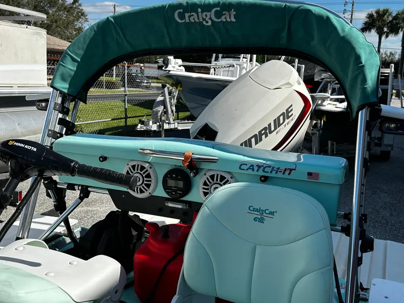 Slide: The Image of 2020 CraigCat CATCHIT boat with Evinrude motor, featuring teal seating and canopy. - 8