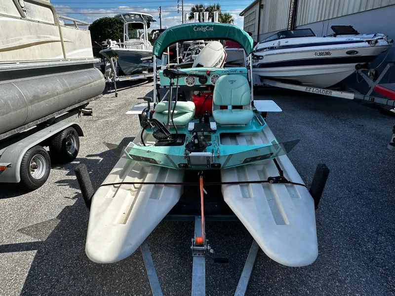Slide: The Image of 2020 CraigCat CATCHIT catamaran on trailer, parked among other boats. - 9