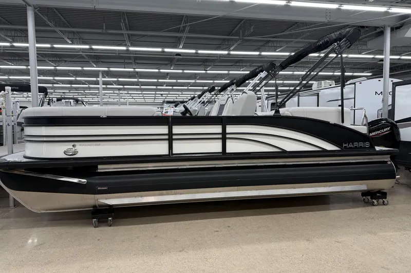 The Image of 2025 Harris Sunliner 230 pontoon boat displayed indoors, featuring sleek design and modern amenities. - 0