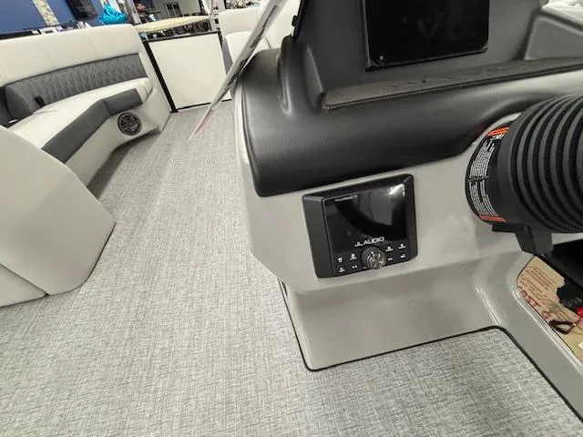 Slide: The Image of 2025 Harris Sunliner 230 boat interior with JL Audio system and seating area. - 10