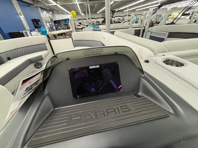 Slide: The Image of 2025 Harris Sunliner 230 boat interior with Simrad display and seating area. - 11