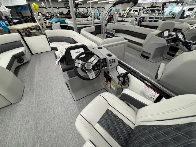 Slide: The Image of 2025 Harris Sunliner 230 boat interior with modern seating and steering console. - 14