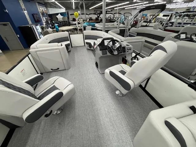 Slide: The Image of Interior view of 2025 Harris Sunliner 230 pontoon boat with modern seating and steering console. - 15