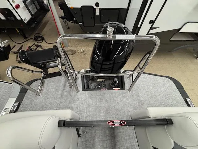Slide: The Image of 2025 Harris Sunliner 230 boat interior with motor, chrome railings, and seating. - 19