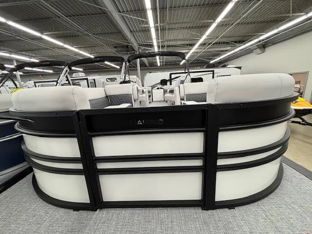Slide: The Image of 2025 Harris Sunliner 230 pontoon boat displayed indoors, showcasing sleek design and modern features. - 2