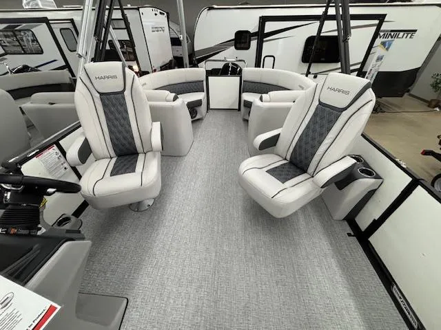 Slide: The Image of 2025 Harris Sunliner 230 boat interior with plush seating and modern design. - 23