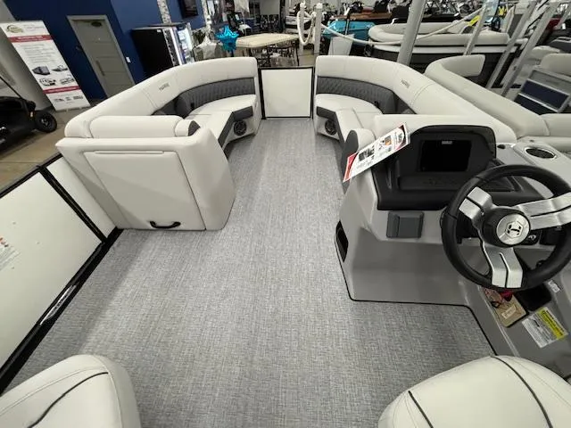 Slide: The Image of Interior view of 2025 Harris Sunliner 230 pontoon boat with spacious seating and modern helm. - 9