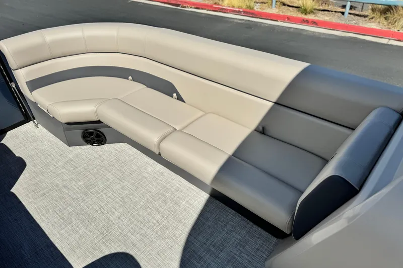 Slide: The Image of Luxurious seating on 2025 Flagship E22RF boat, featuring beige upholstery and integrated speaker. - 11