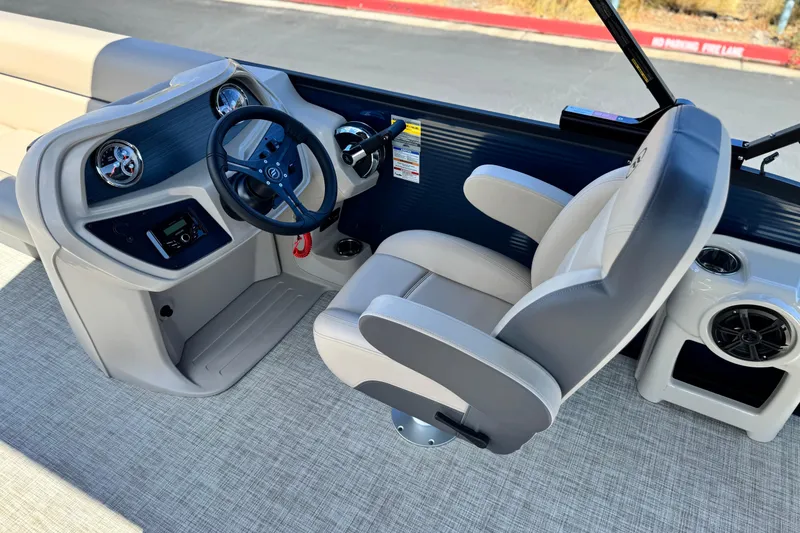 Slide: The Image of Captain's seat and dashboard of 2025 Flagship E22RF boat, featuring modern controls and steering. - 18