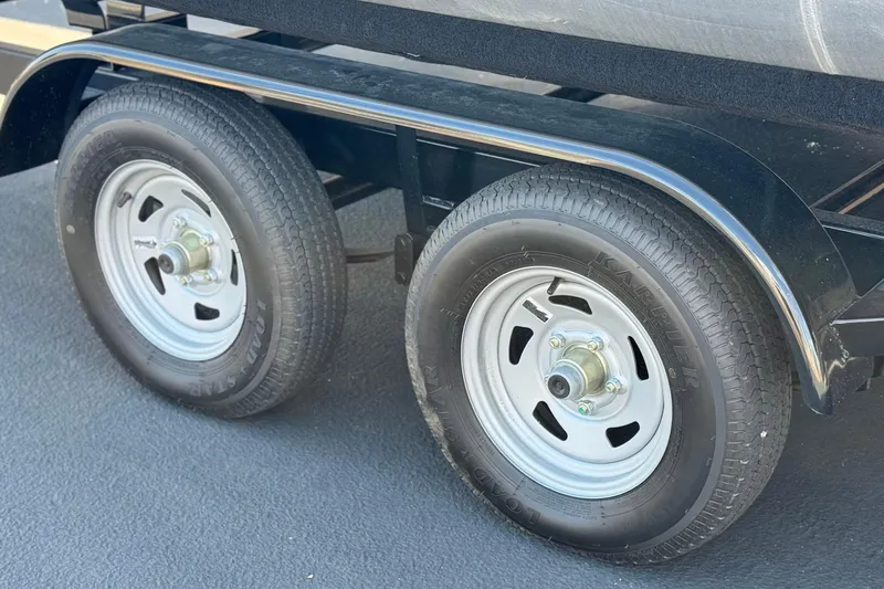Slide: The Image of Dual wheels on a 2025 Flagship E22RF trailer, featuring durable tires and metal rims. - 21