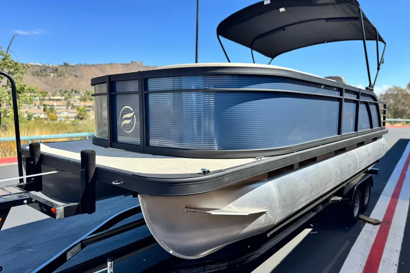Slide: The Image of 2025 Flagship E22RF pontoon boat on trailer, featuring sleek design and canopy. - 3
