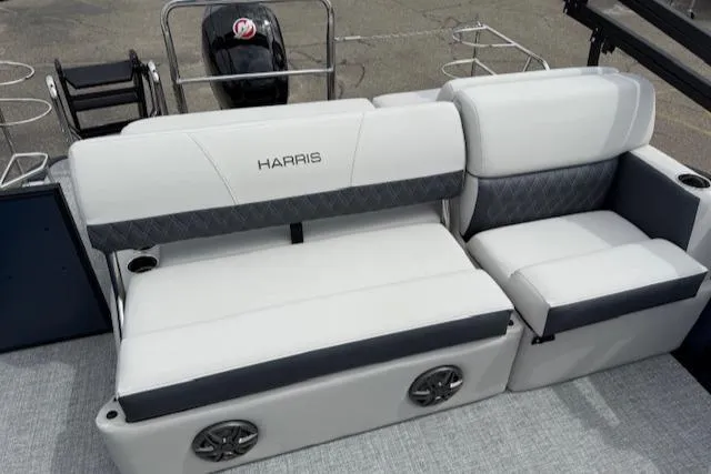 Slide: The Image of 2025 Harris Sunliner 230 boat interior with plush seating and integrated speakers. - 11