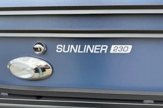 Slide: The Image of 2025 Harris Sunliner 230 boat emblem on a sleek blue surface. - 16
