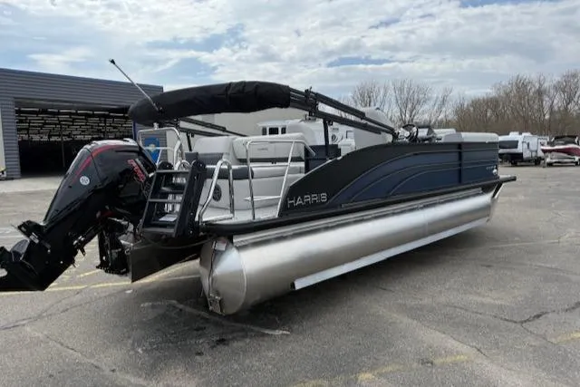 Slide: The Image of 2025 Harris Sunliner 230 pontoon boat with sleek design, parked outdoors. - 20