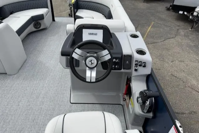 Slide: The Image of 2025 Harris Sunliner 230 boat interior with steering wheel and seating. - 7