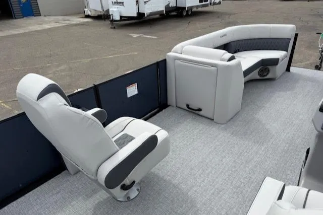 Slide: The Image of 2025 Harris Sunliner 230 boat interior with plush seating and modern design. - 8