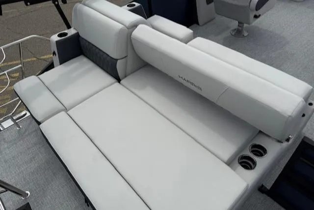 Slide: The Image of 2025 Harris Sunliner 230 boat interior with luxurious white seating and cup holders. - 9