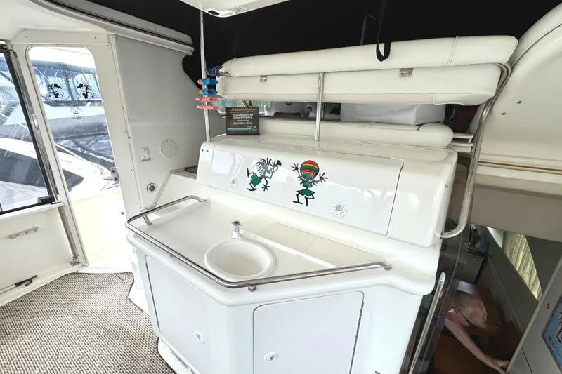 Slide: The Image of 1997 Sea Ray 370 Aft Cabin interior with sink and playful wall art. - 11