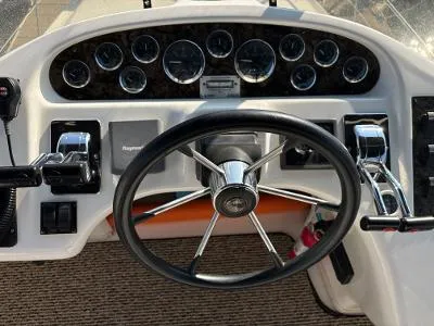 Slide: The Image of 1997 Sea Ray 370 Aft Cabin helm with steering wheel and instrument panel. - 13
