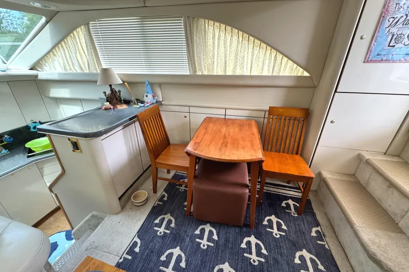 Slide: The Image of Interior of 1997 Sea Ray 370 Aft Cabin with dining area and nautical decor. - 17