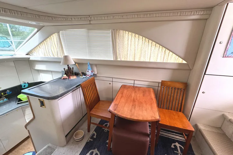 Slide: The Image of Interior of 1997 Sea Ray 370 Aft Cabin with dining area and kitchenette. - 18