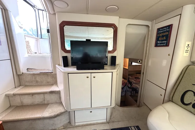 Slide: The Image of Interior of 1997 Sea Ray 370 Aft Cabin with TV, stairs, and cozy seating area. - 20