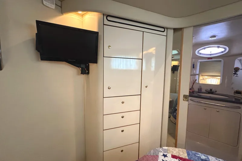 Slide: The Image of Interior of 1997 Sea Ray 370 Aft Cabin with TV and storage cabinets. - 24