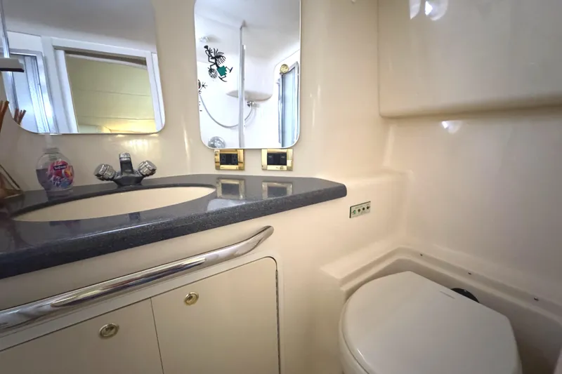 Slide: The Image of 1997 Sea Ray 370 Aft Cabin bathroom with sink, mirror, and toilet. - 26