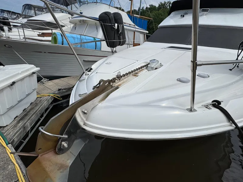Slide: The Image of 1997 Sea Ray 370 Aft Cabin yacht docked, showcasing anchor and deck details. - 3