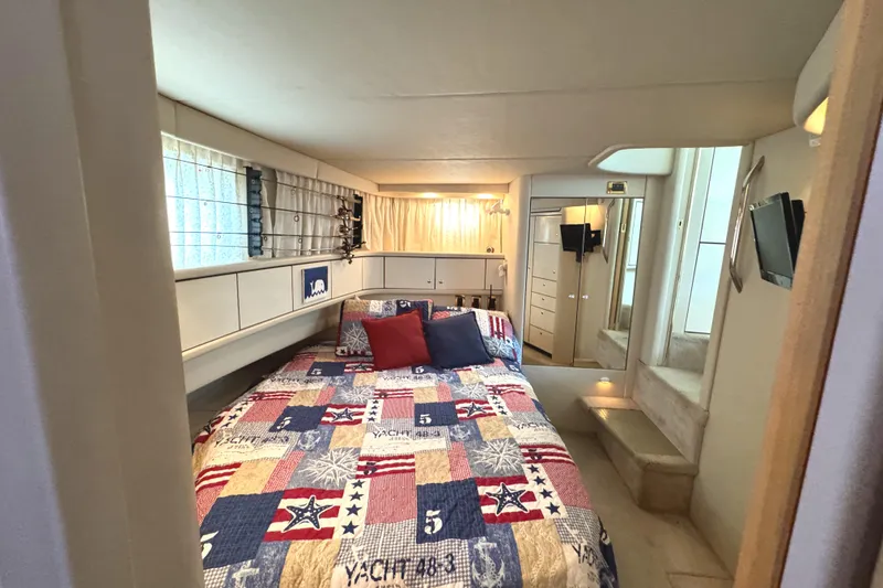 Slide: The Image of Cozy bedroom in 1997 Sea Ray 370 Aft Cabin yacht with nautical-themed bedding. - 30