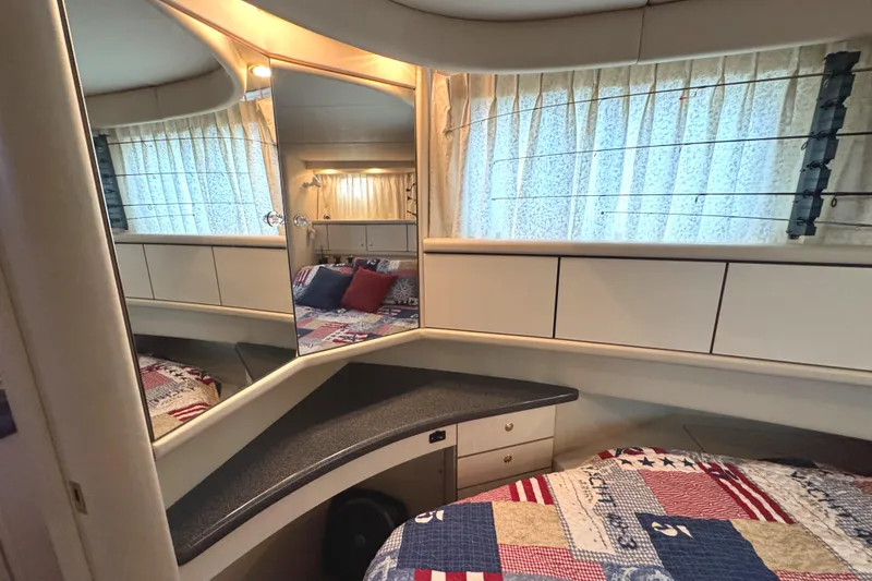 Slide: The Image of Interior of 1997 Sea Ray 370 Aft Cabin with cozy bed and mirrored wall. - 32
