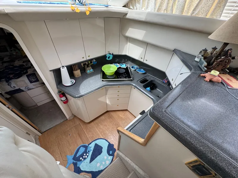 Slide: The Image of 1997 Sea Ray 370 Aft Cabin kitchen with modern appliances and ample counter space. - 33