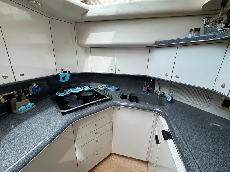 Slide: The Image of 1997 Sea Ray 370 Aft Cabin kitchen with sleek countertops and modern appliances. - 34