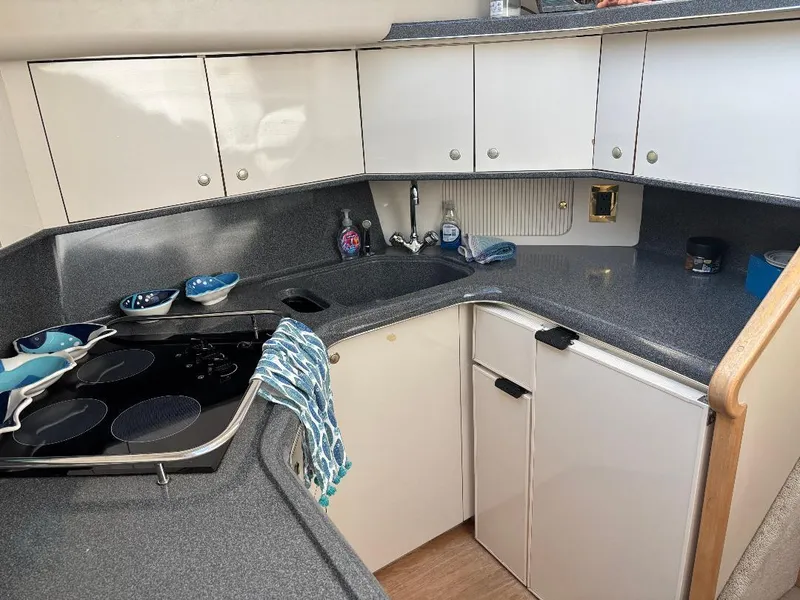 Slide: The Image of 1997 Sea Ray 370 Aft Cabin kitchen with modern appliances and sleek cabinetry. - 35