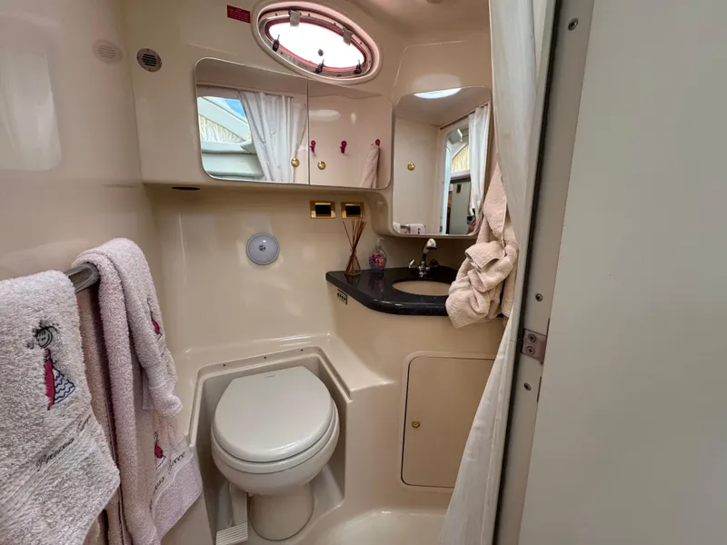 Slide: The Image of Bathroom interior of 1997 Sea Ray 370 Aft Cabin yacht, featuring toilet and sink. - 38