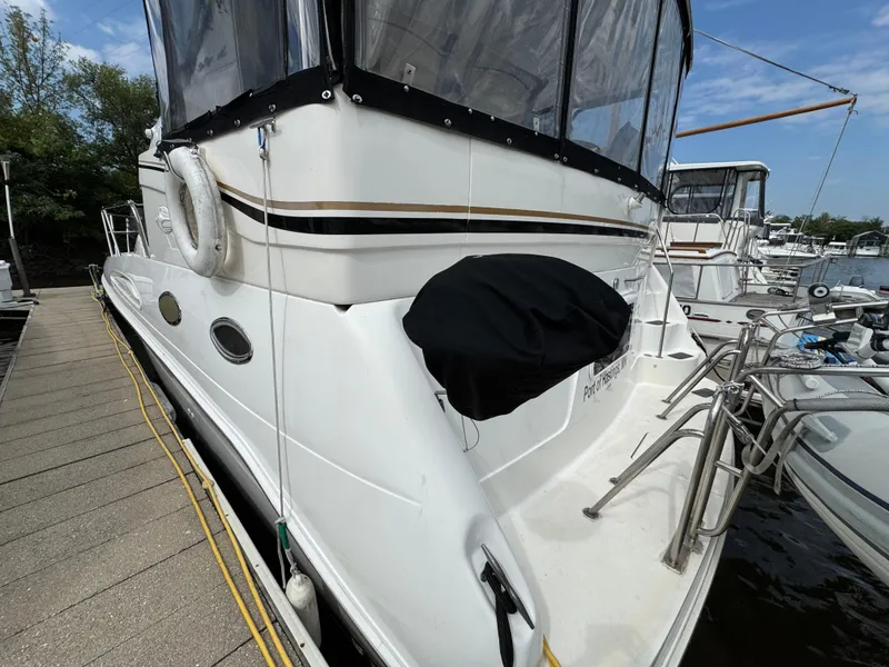 Slide: The Image of 1997 Sea Ray 370 Aft Cabin yacht docked at marina, side view. - 4