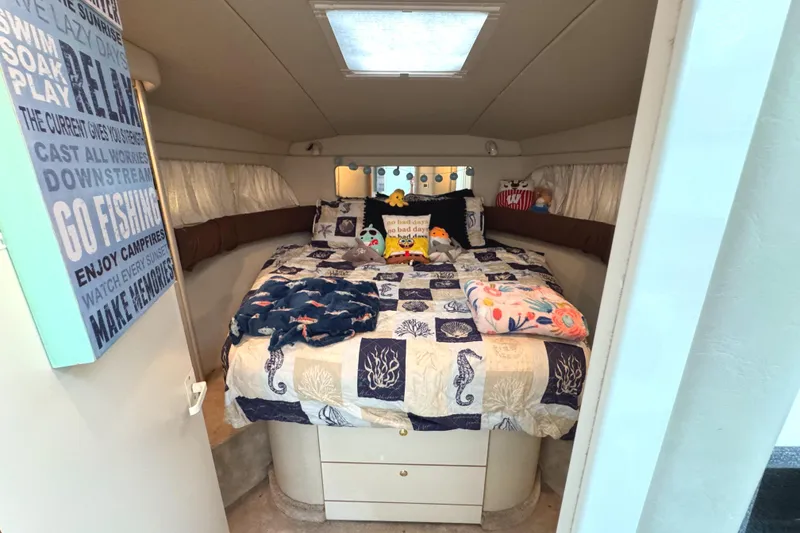 Slide: The Image of Cozy bedroom in 1997 Sea Ray 370 Aft Cabin with nautical-themed bedding and decor. - 42