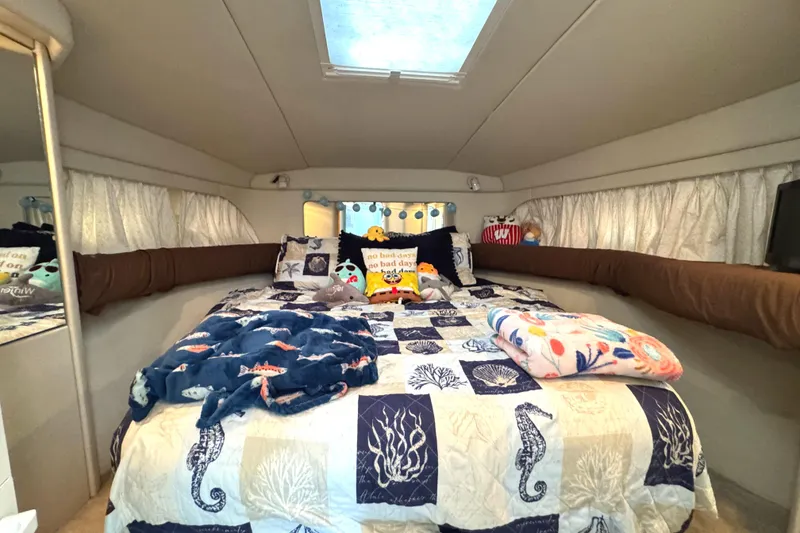 Slide: The Image of Cozy bedroom in 1997 Sea Ray 370 Aft Cabin with nautical-themed bedding and plush toys. - 44