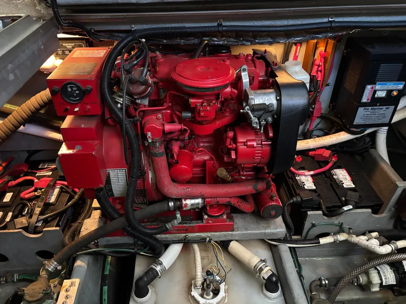 Slide: The Image of Engine room of a 1997 Sea Ray 370 Aft Cabin with red machinery and wiring. - 49
