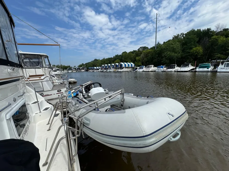 Slide: The Image of Docked 1997 Sea Ray 370 Aft Cabin with inflatable dinghy on a sunny day. - 6